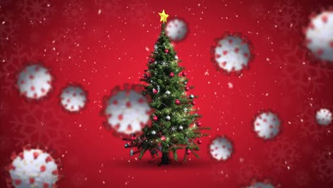 Animation-of-covid-19-cells-moving-over-winter-scenery-with-christmas-tree-and-snow-falling