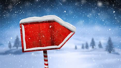 Digital-animation-of-snow-falling-over-red-wooden-sign-post-on-winter-landscape