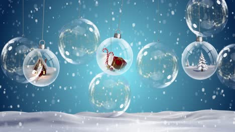 Animation-of-clear-christmas-baubles-hanging-and-snow-falling-on-blue-background