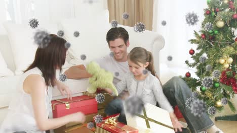 Animation-of-covid-19-cells-moving-over-caucasian-couple-with-daughter-at-christmas-giving-presents-