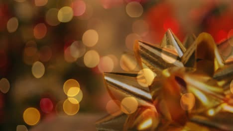 Animation-of-christmas-golden-ribbon-over-flickering-fairy-lights