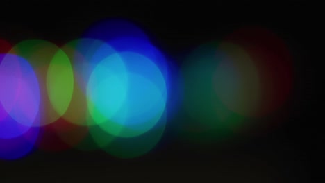 Multiple-multicoloured-lights-flickering-on-black-background