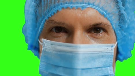 Caucasian-male-doctor-wearing-face-mask-on-green-screen-background