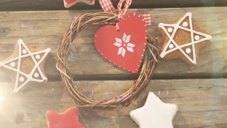 Animation-of-traditional-gingerbread-cookies-and-christmas-decoration-on-wooden-background