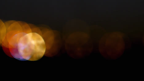 Animation-of-multiple-flickering-yellow-spots-of-light-on-black-background