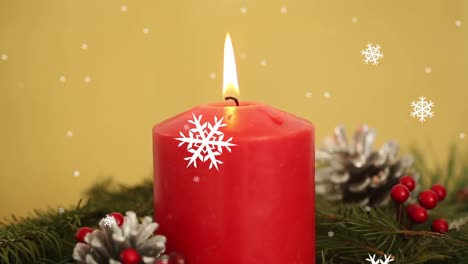Animation-of-christmas-candle-and-decoration-with-snowflakes-falling
