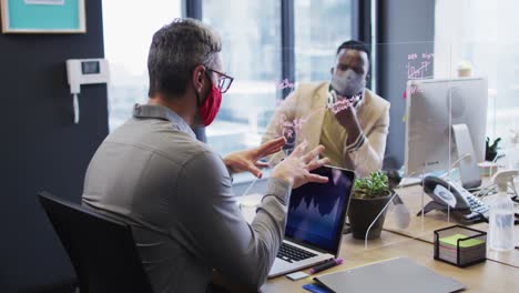 Diverse-male-office-colleagues-wearing-face-masks-discussing-at-modern-office