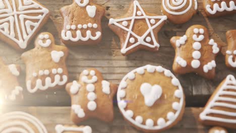 Animation-of-gingerbread-cookies-on-wooden-rustic-surface