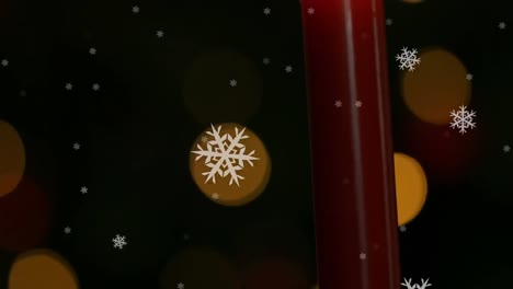 Animation-of-lit-candle-with-spots-of-light-and-snowflakes