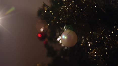Animation-of-decorated-christmas-tree-with-baubles-and-spots-of-light