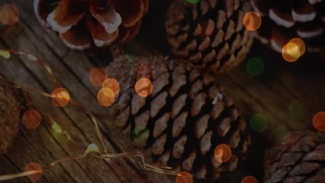 Animation-of-christmas-pine-cones-decorations-with-glowing-lights