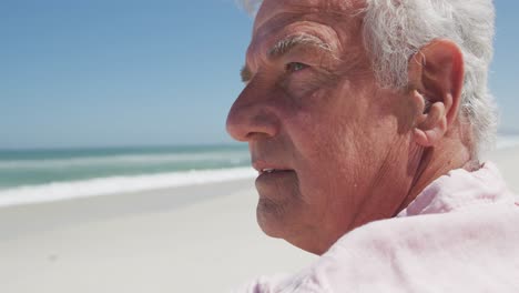 Close-up-view-of-thoughtful-senior-caucasian-man-sitting-on-the-beach
