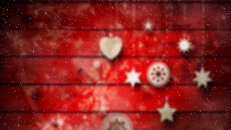 Animation-of-christmas-baubles-decoration-with-snow-falling-on-red-boards
