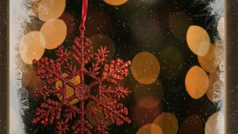 Animation-of-red-christmas-decoration-with-snow-falling-and-lights