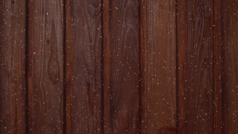 Animation-of-winter-scenery-with-snow-falling-over-wooden-boards