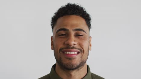 Portrait-of-mixed-race-man-looking-at-camera-and-smiling