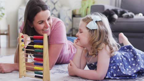 Caucasian-mother-and-daughter-having-fun-using-abacus
