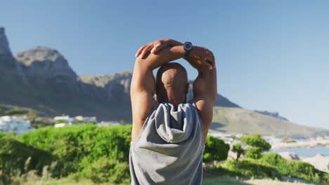 Senior-african-american-man-exercising-stretching-listening-to-music