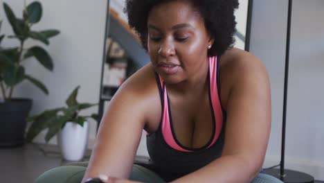 African-american-female-plus-size-vlogger-recording-a-video-about-working-out