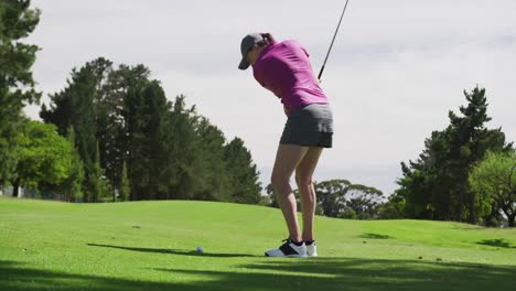 Caucasian-woman-playing-golf-taking-a-shot-from-bunker