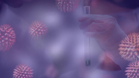 Animation-of-3d-covid-19-cells-floating-over-scientist-holding-test-tube-with-liquid