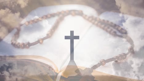 Animation-of-christian-cross,-rosary-and-holy-bible-over-clouds