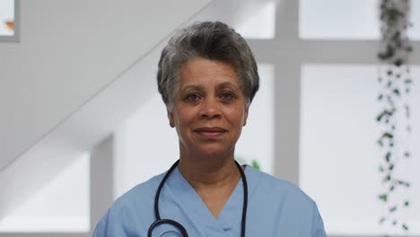 Portrait-of-senior-african-american-female-doctor-looking-at-camera-and-smiling