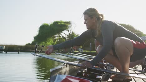 Senior-caucasian-woman-preparing-rowing-boat-in-a-river