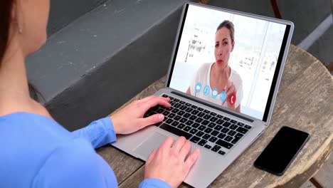 Caucasian-woman-using-laptop-on-video-call-with-female-colleague-working-from-home