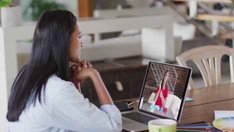 Caucasian-woman-using-laptop-on-video-call-with-female-colleague