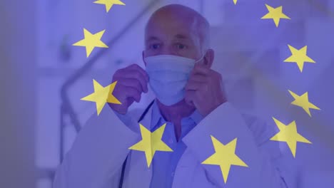 Animation-of-flag-of-eurpean-union-and-statistics-with-male-doctor-putting-on-face-mask