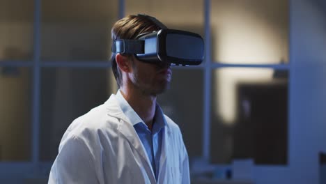 Caucasian-male-doctor-wearing-vr-headset-using-virtual-interface