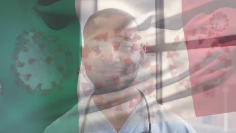 Animation-of-flag-of-italy-with-floating-covid-cells-and-smiling-male-doctor