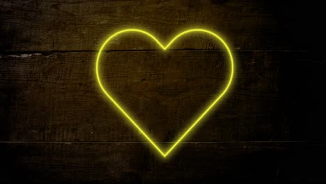 Animation-of-yellowneon-heart-flashing-on-dark-wood-background