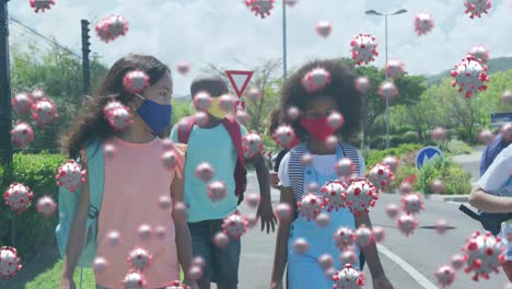 Animation-of-floating-covid-19-cells-and-schoolchildren-wearing-face-masks-walking-to-school
