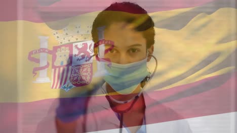 Animation-of-flag-of-spain-with-female-doctor-wearing-mask-holding-stethoscope