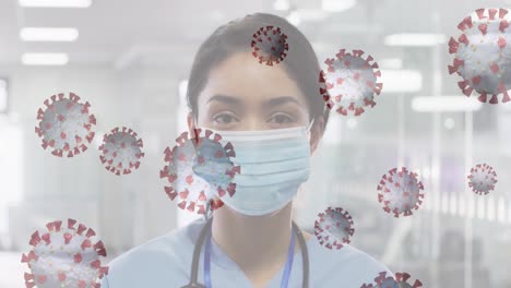 Animation-of-floating-covid-19-cells-with-scientist-looking-at-camera-wearing-face-masks