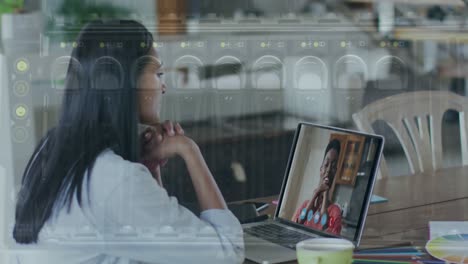 Animation-of-close-up-of-computer-server-over-woman-using-laptop-on-video-call-in-background