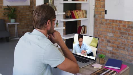 Caucasian-male-teacher-using-laptop-on-video-call-with-male-student