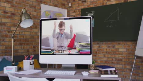 Caucasian-schoolboy-learning-displayed-on-computer-screen-during-video-call