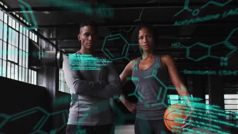 Animation-of-statistics-and-graphs-over-man-and-woman-standing-and-holding-basketball