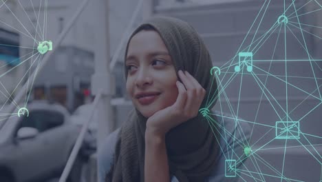 Animation-of-a-moving-network-of-connected-media-icons-with-smiling-woman-wearing-hijab