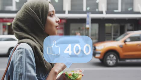 Thumbs-up-icon-with-increasing-likes-against-woman-in-hijab-walking-on-the-street-with-a-snack
