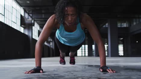 Animation-of-fight-fight-text-over-mixed-race-woman-doing-push-ups