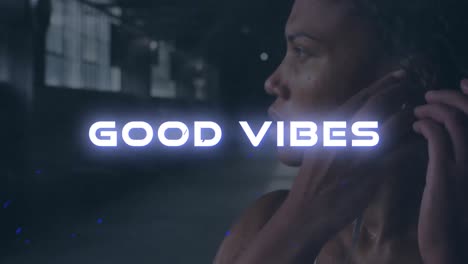 Animation-of-good-vibes-text-over-mixed-race-woman-listening-to-music