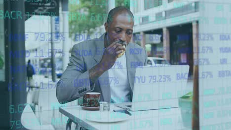 Stock-market-data-processing-against-african-american-senior-man-having-a-snack-while-using-laptop