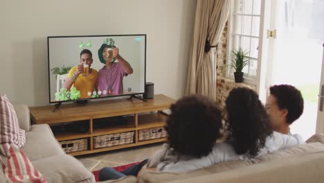 African-american-family-at-home-using-digital-tv-making-video-call-on-st-patrick's-day