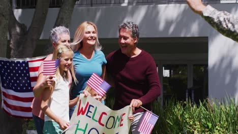 Caucasian-military-man-in-uniform-hugging-his-family-in-the-garden