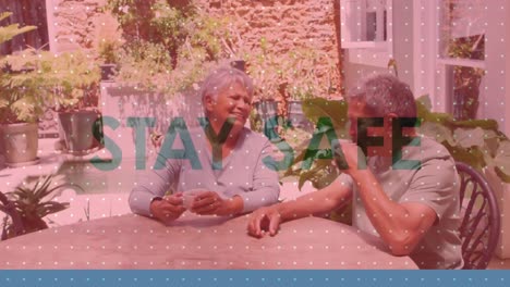 Animation-of-stay-home-over-senior-couple-talking-at-home