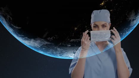 Portrait-of-female-surgeon-wearing-face-mask-against-globe-on-blue-background